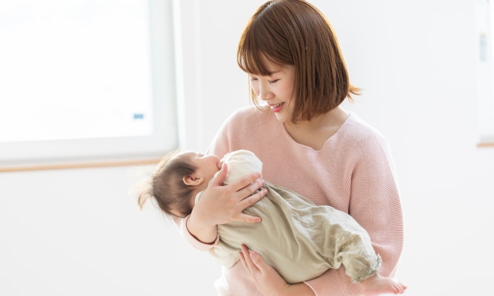 赤ちゃんの抱っこをする産後のママ